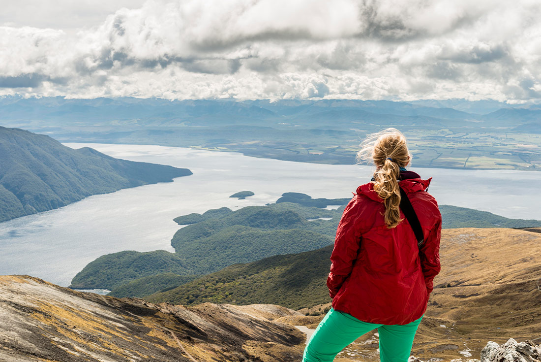 Traveller looking at view from Kepler Track, New Zealand
