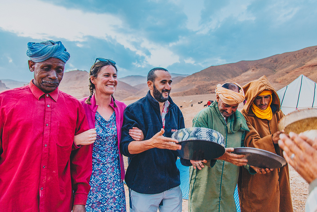 Travellers and local berbers at desert camp, Sahara, Morocco
