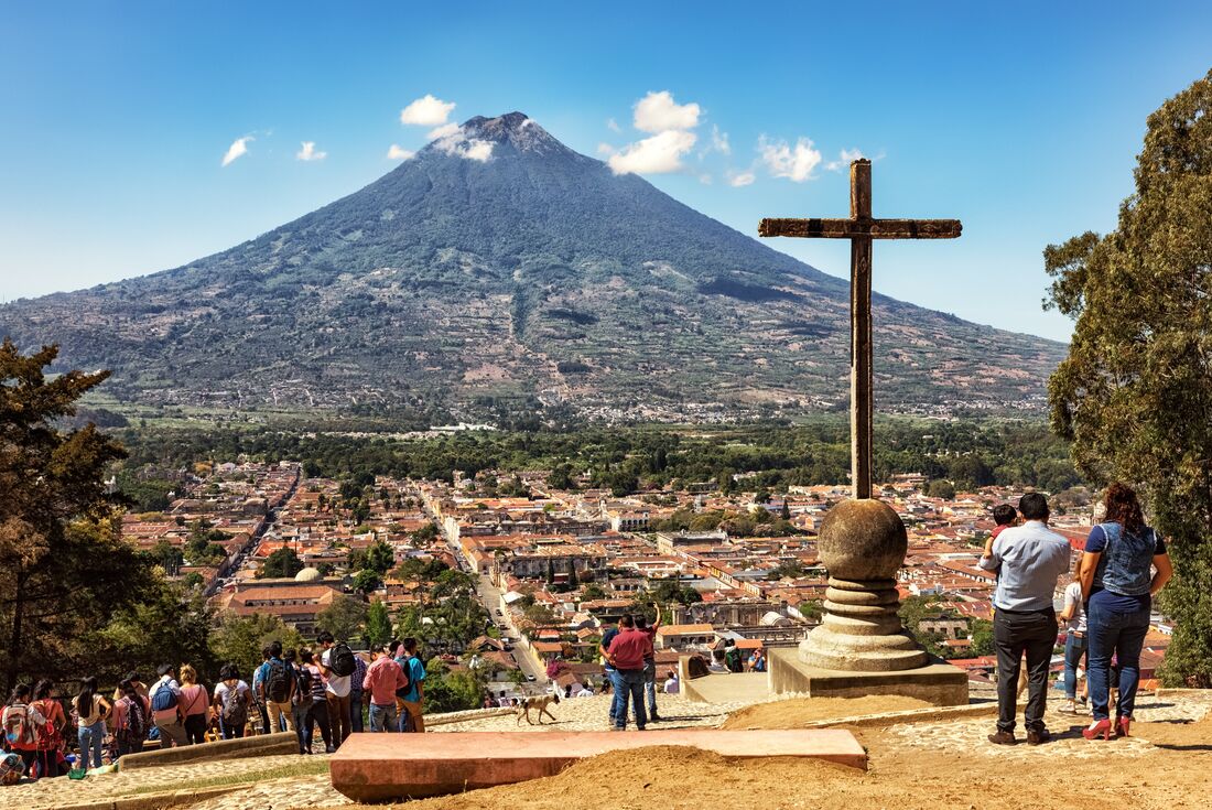 Travellers and locals look out from the viewpoint of Cerro de la Cruz, Antigua Guatemala