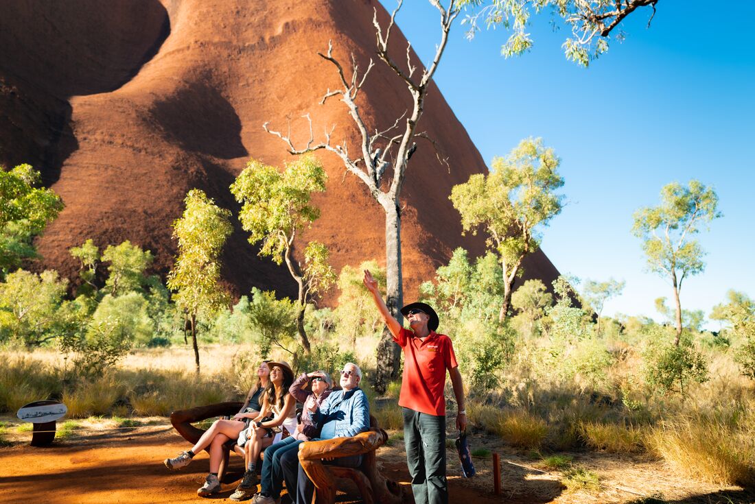 Intrepid leader gives a talk at the base of Uluru in Northern Territory's Red Centre in Australia