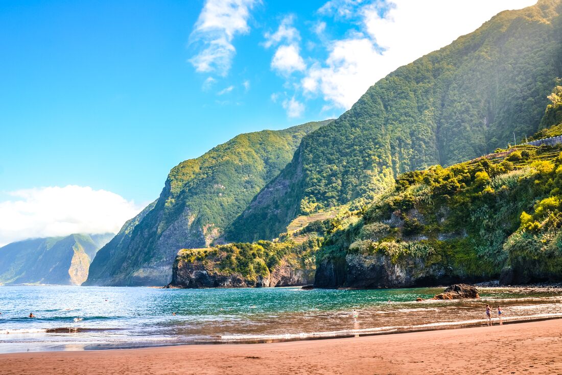 Idyllic beach surrounded by towering cliffs of Madeira in the North Atlantic