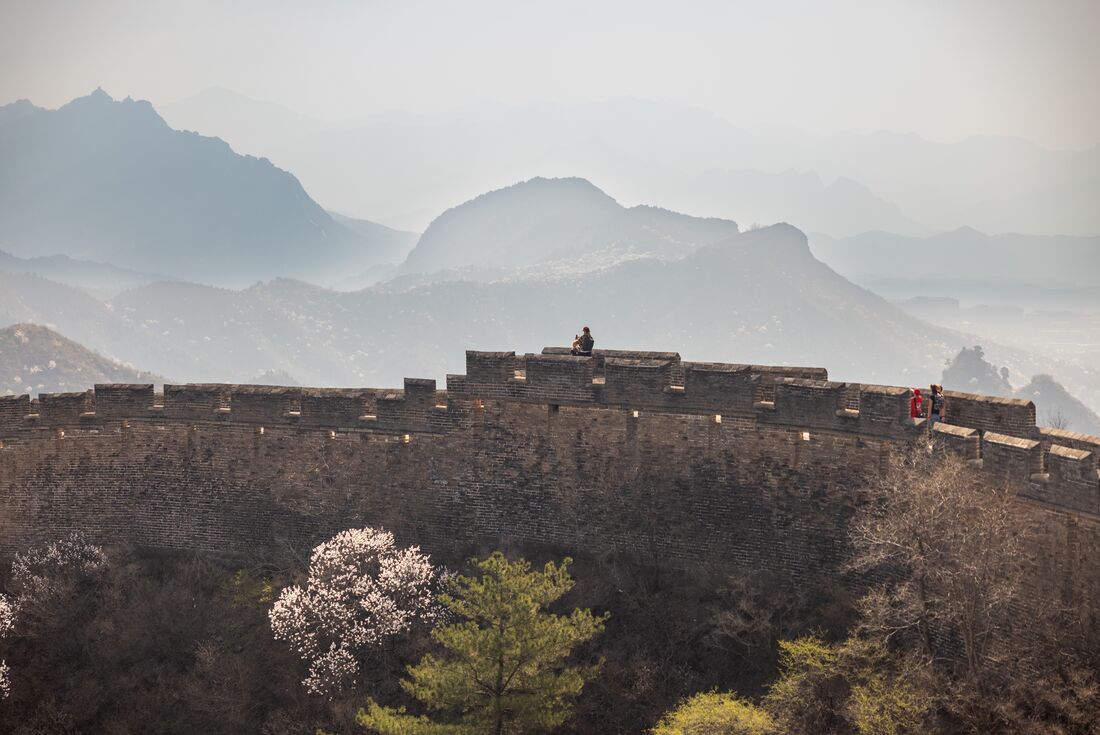 A section of the Great Wall with mountains in the background and trees in the foreground, Beijin, China