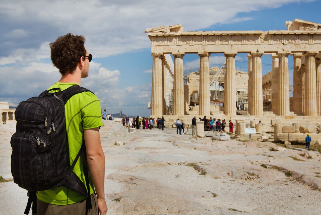Intrepid travellers looks out at the Parthenon in Athens Acropolis