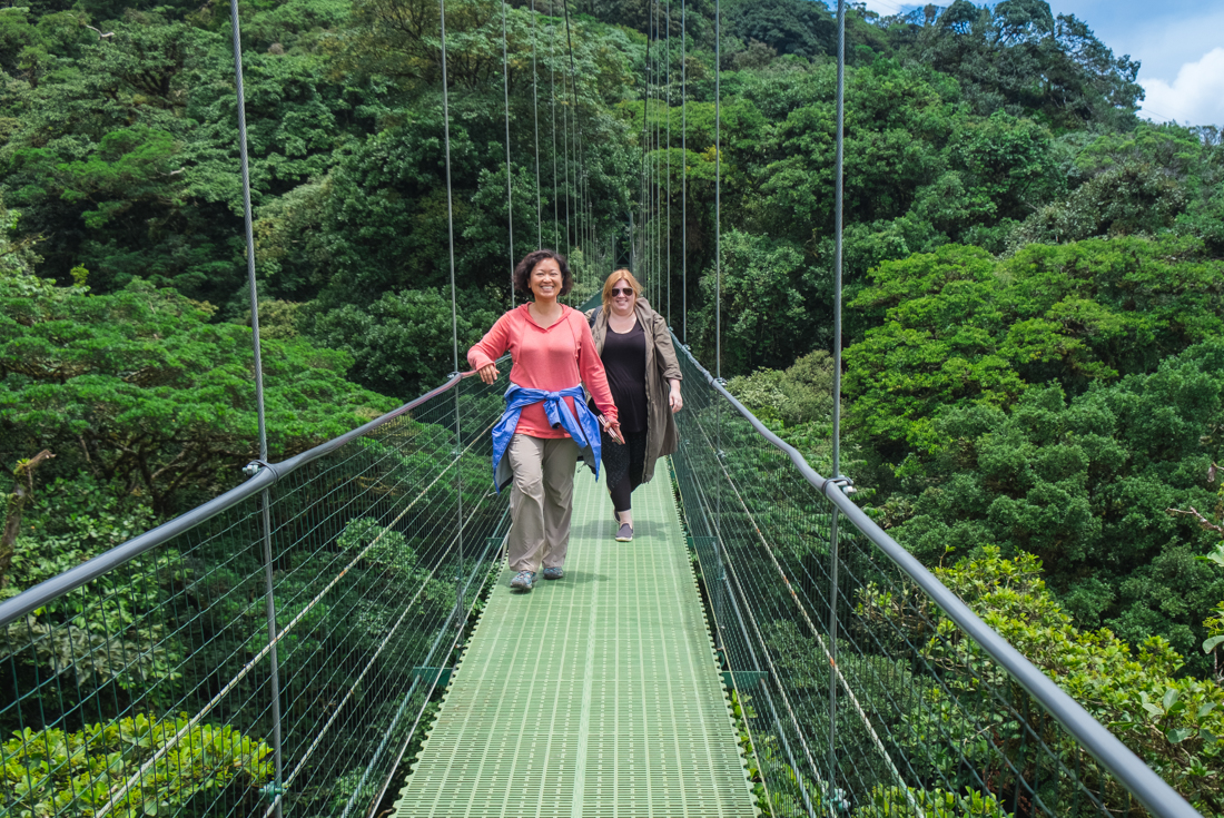Intrepid travellers emerge from Monteverde cloud forest into the sunlight on a suspension bridge in Costa Rica