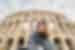 Traveller taking a selfing in front of the Colosseum in Rome, Italy.