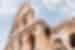 Looking up at the architecture of the Colosseum in Rome, the capital of Italy with a sky backdrop