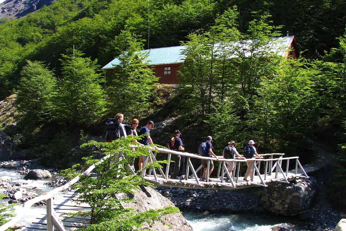 Group of travellers crossing a bridge in Torres del Paine NP, Patagonia, Chile