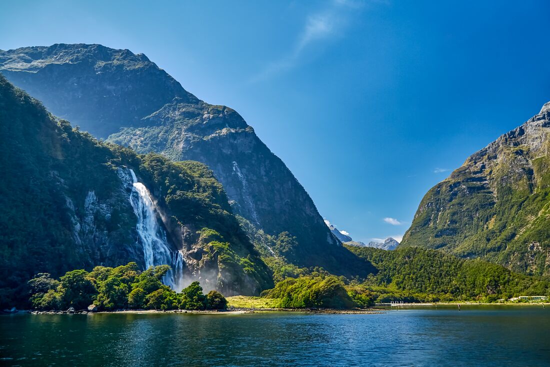 Milford Sound's majestic towering hills with Bowen Falls cascading into the sound on New Zealand South Island
