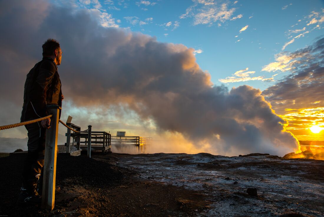 Intrepid traveller looks at the steam from Gunnuhver hot springs at Reykjanes Penninsula in Iceland