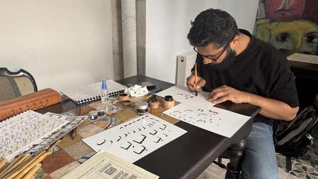A man practising calligraphy