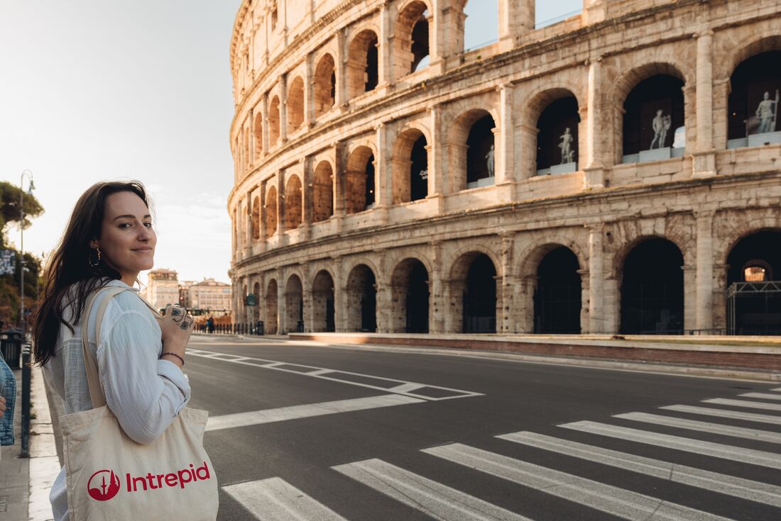 Traveller visits the Colosseum at dawn, Rome, Italy
