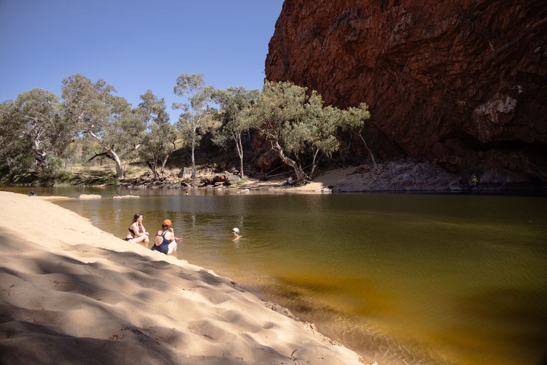 Group enjoying swimming hole in Tjoritja, West MacDonnell Ranges, Australia