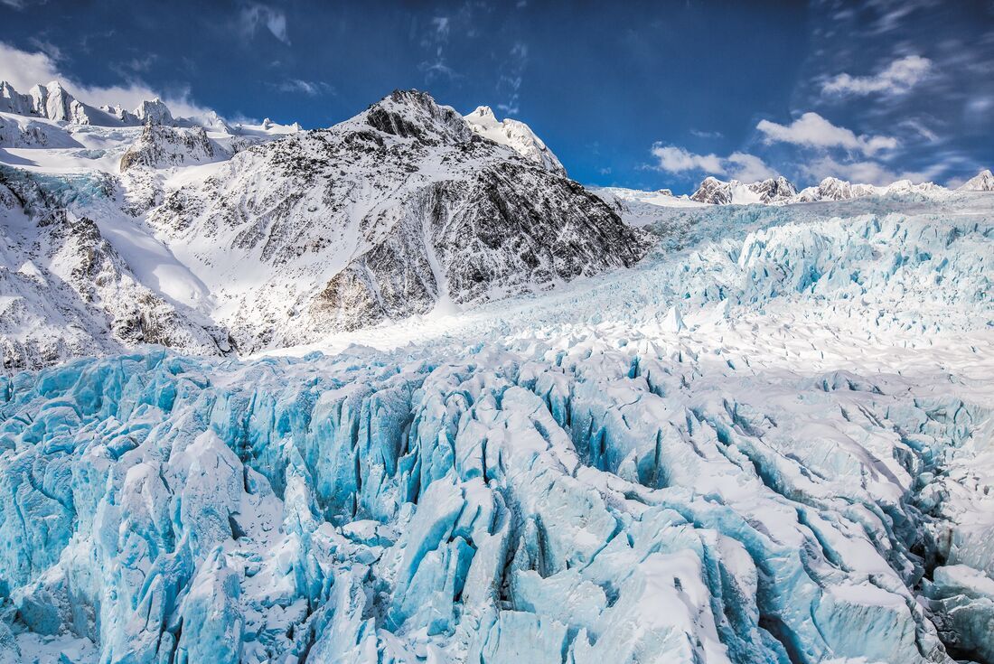 Icy snowcapped peaks of Franz Josef Glacier, New Zealand