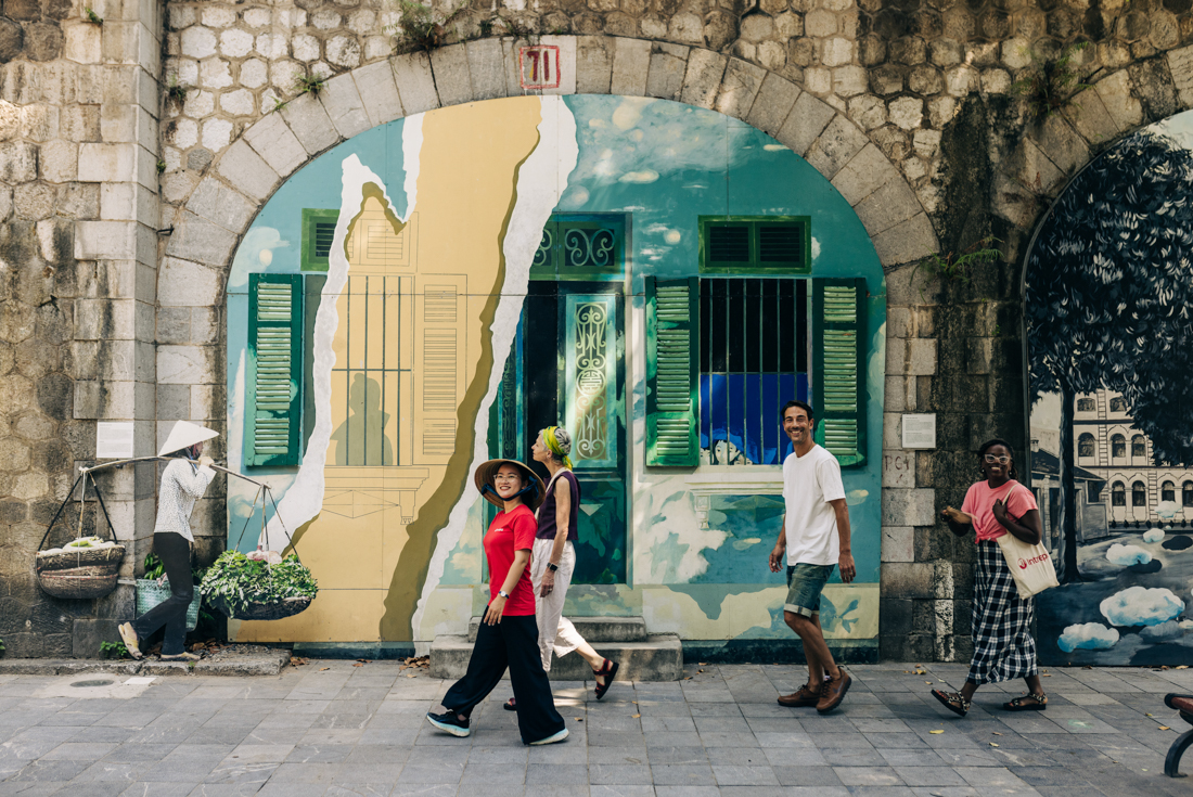 Intrepid leader and travellers walking the streets of Hanoi