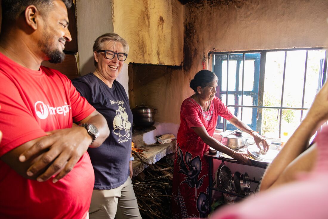 Traveler laughing with guide at Travel group at Family Family lunch, Bandarawela