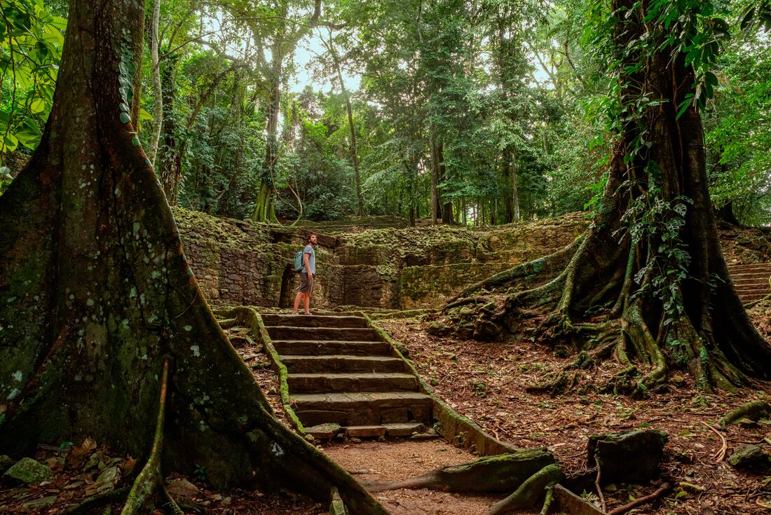 Traveller in Palenque Mayan ruins in the rainforests of Mexico