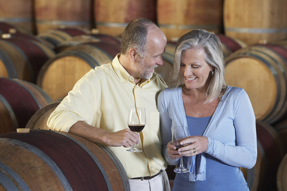 Couple trying wine on a wine cellar tour, Azuga, Romania
