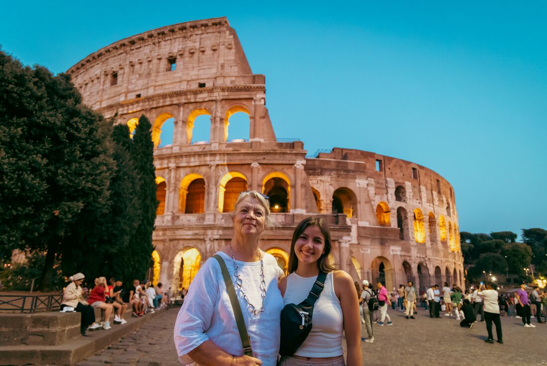 Intrepid travellers pose outside Rome's Colosseum in Italy