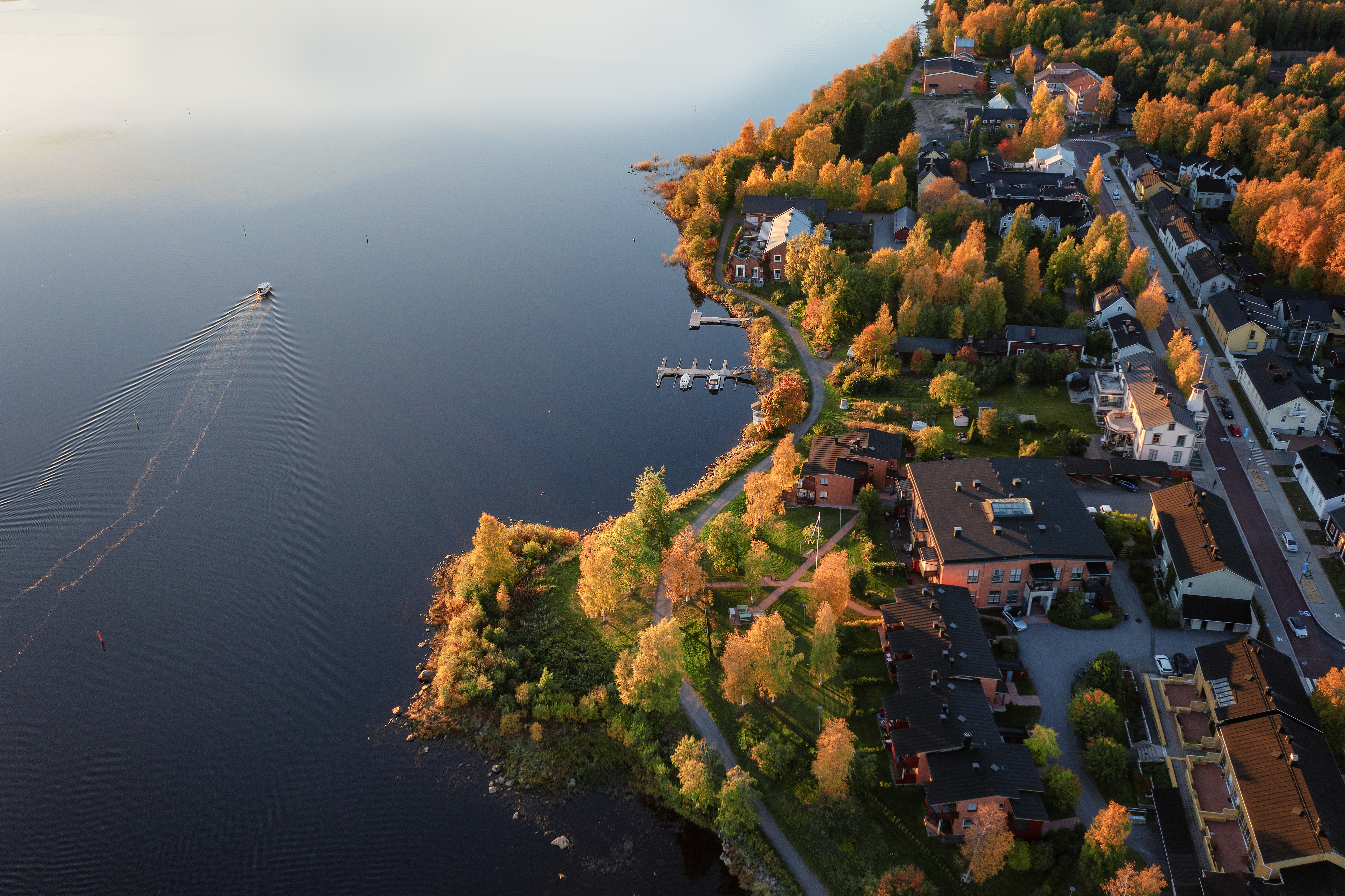 A bird's eye view of a coastline in Oulu, Finland during sunrise in autumn.